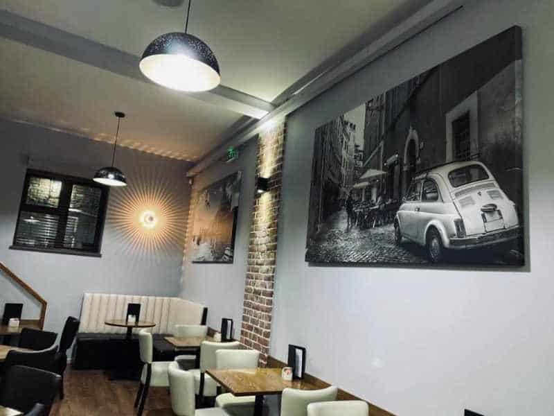 Interior cafe wall with Italian art