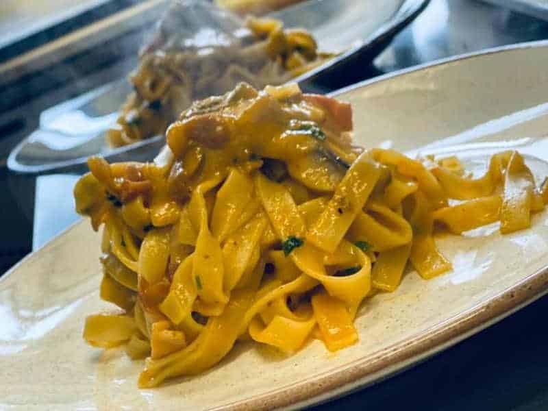 Tagliatelle steaming hot served on a plate